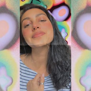 brown haired woman in stripy top with colourful background